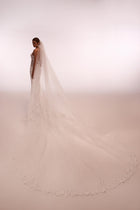 Langer und klassischer Apolonia-Hochzeitsschleier mit floraler Spitze und Kammaufsatz aus dem Dama Couture Brautkleid-Atelier (Foto hinten)