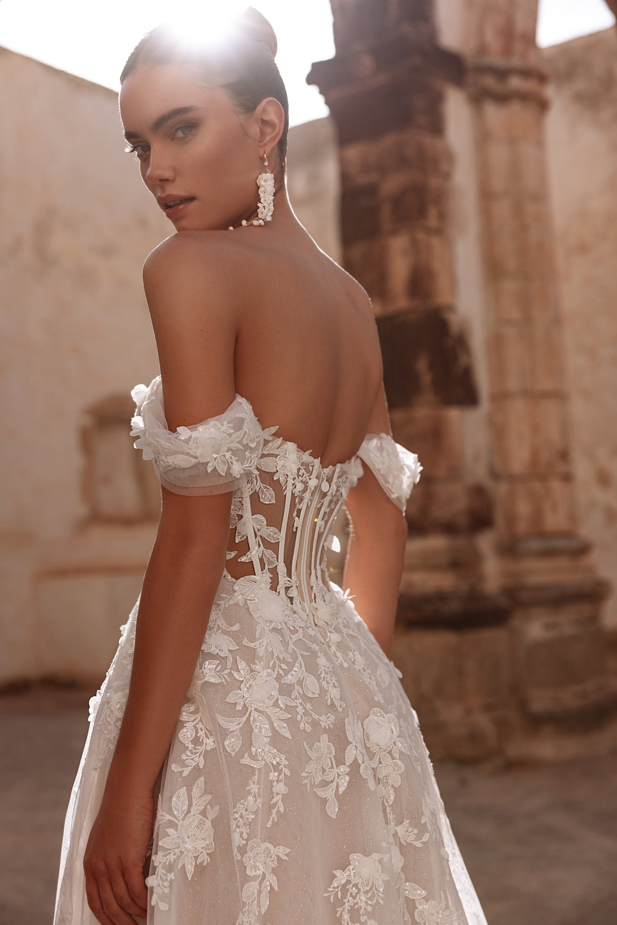 Ariella’s off-shoulder tulle sleeves bring airy elegance and delicate romantic charm to the dress.