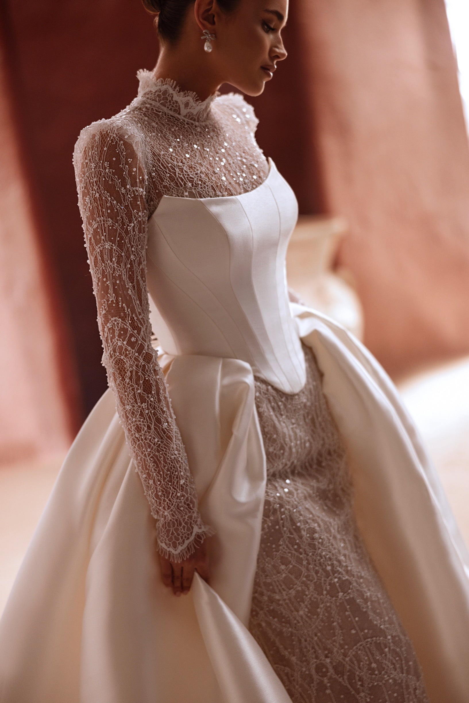 The Henriette overskirt combines detailed lace embroidery with satin overskirt for a glamorous bridal silhouette.