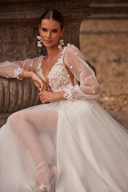 Romantic lace a-line wedding dress with detachable sleeves from DAMA Couture (campaign photo)