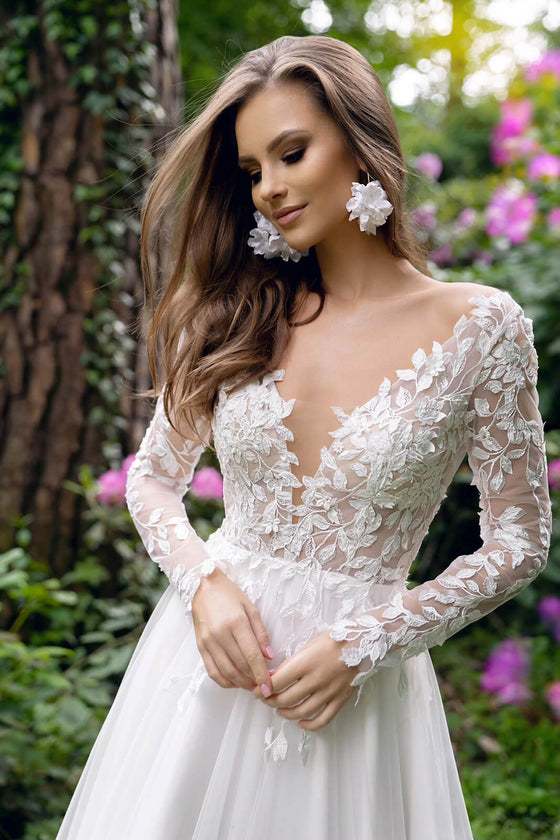 Brautkleid Calista mit langen Spitzenärmeln und Blattranken auf dem Oberteil, im Garten