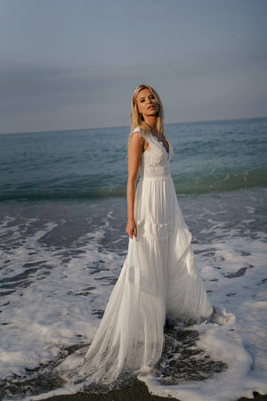 Brautkleid Lidia im flachen Meerwasser, ganze Silhouette in der Abenddämmerung