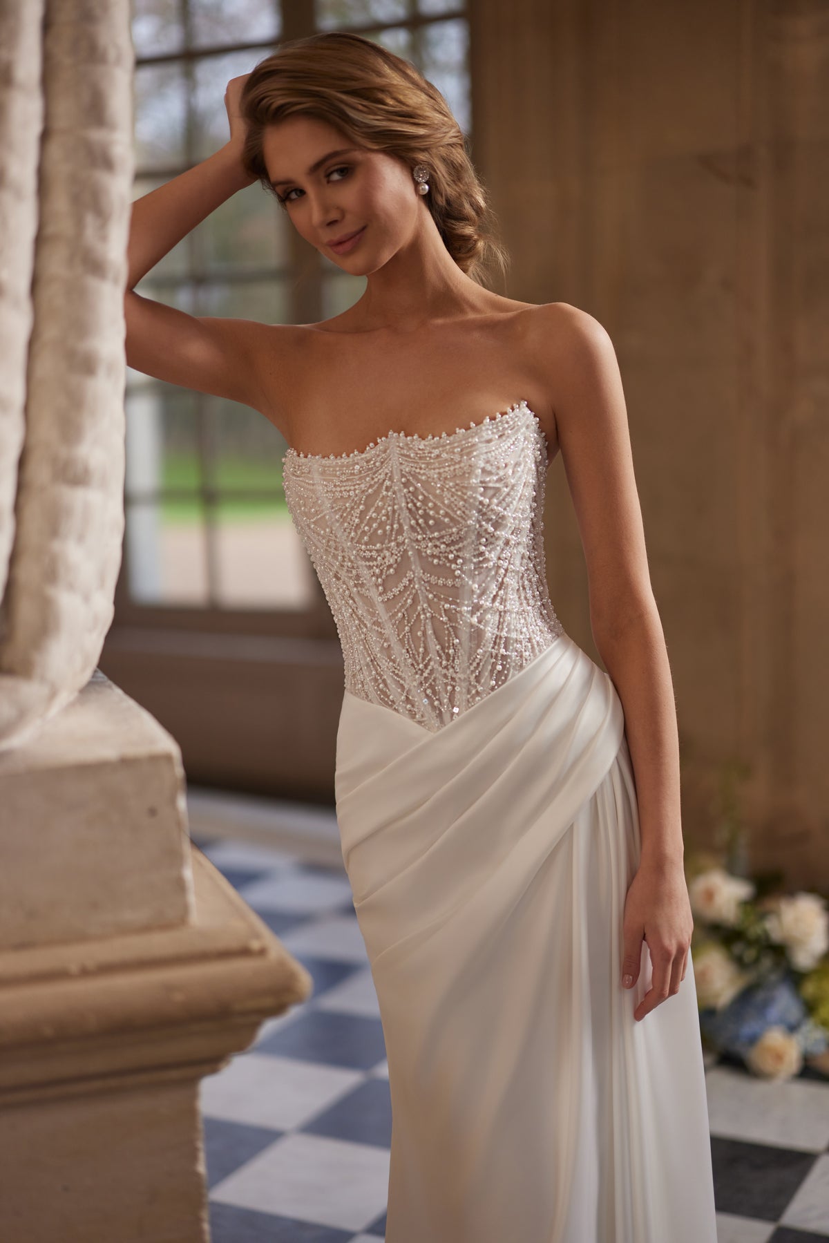 Brautkleid Greta im Detail – trägerlose Corsage mit Perlenstickerei über dem Satinrock
