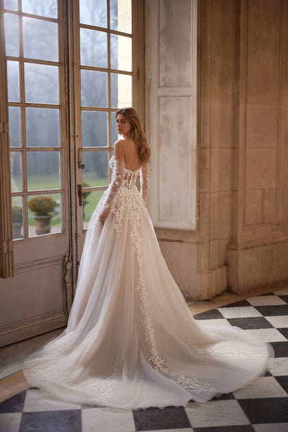 Ines wedding dress – a sculpted strapless bodice and floral lace tulle skirt.