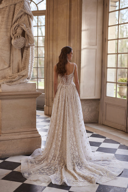 Milkyway wedding dress – a square neckline and star-embroidered tulle skirt.
