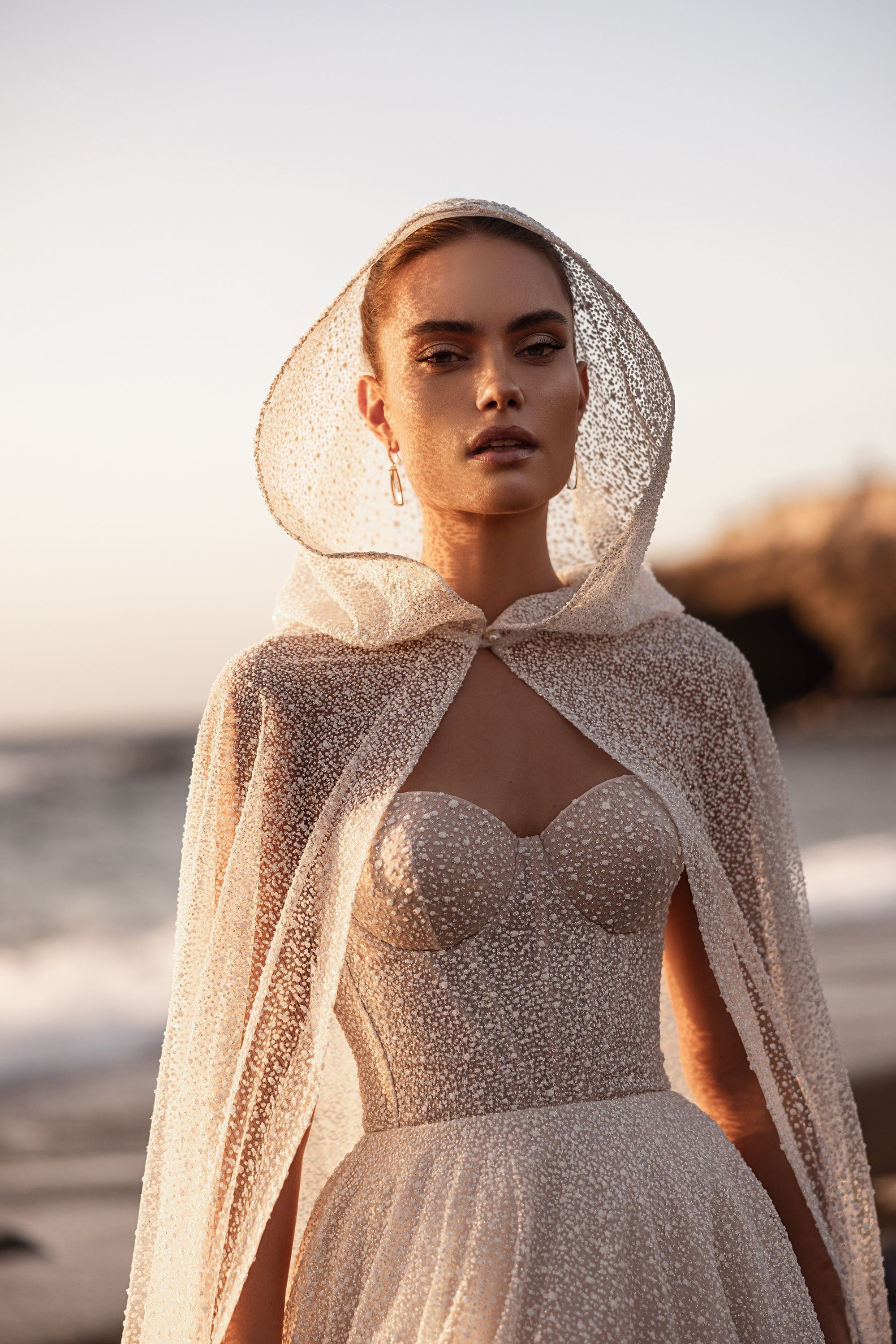 Amira bridal cape with a delicate hood and couture-inspired embellished tulle.