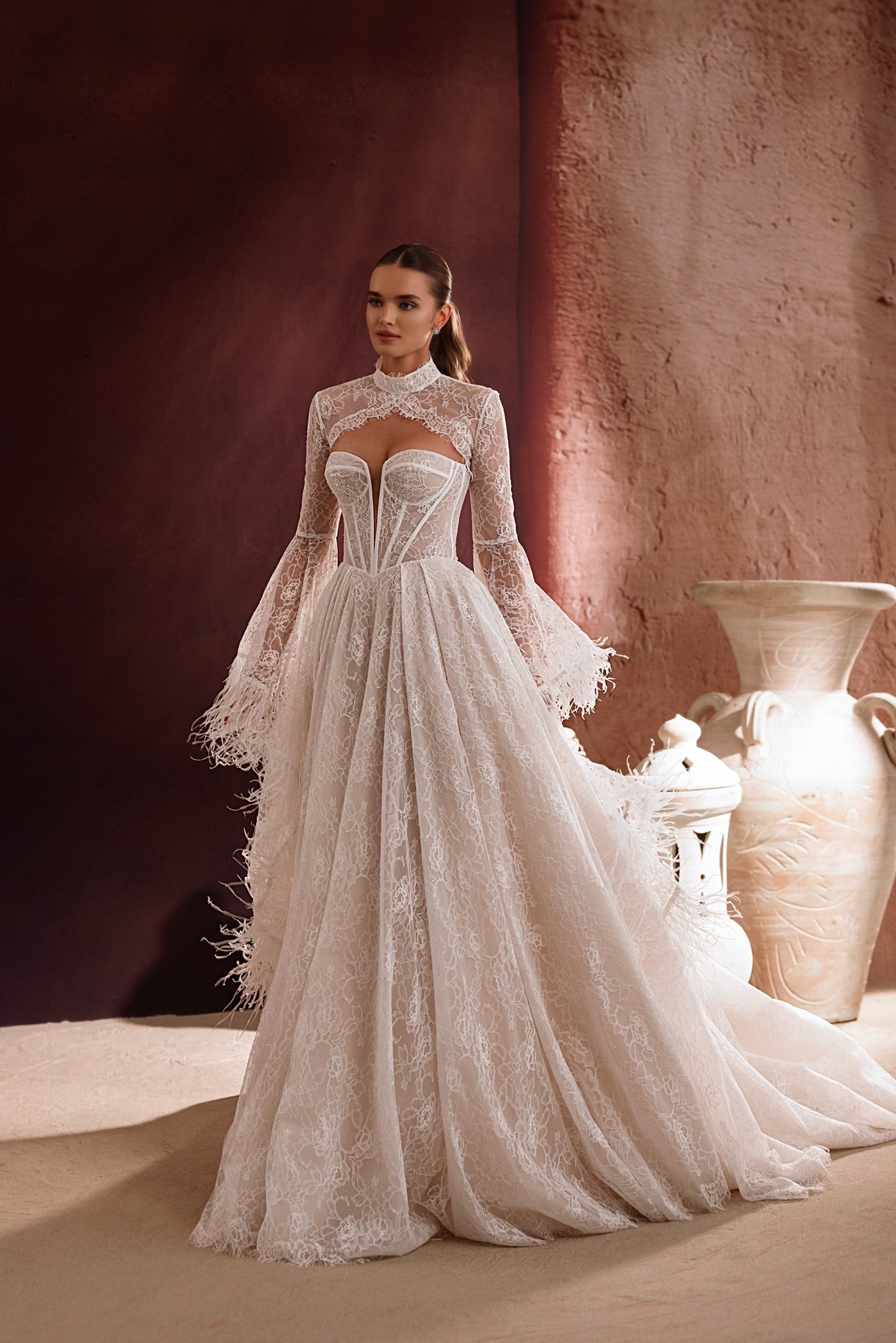 The back of the Michelle wedding dress from the Zahra al-Sahra collection features a long lace train and feather details for a luxurious, fairy-tale bridal look.
