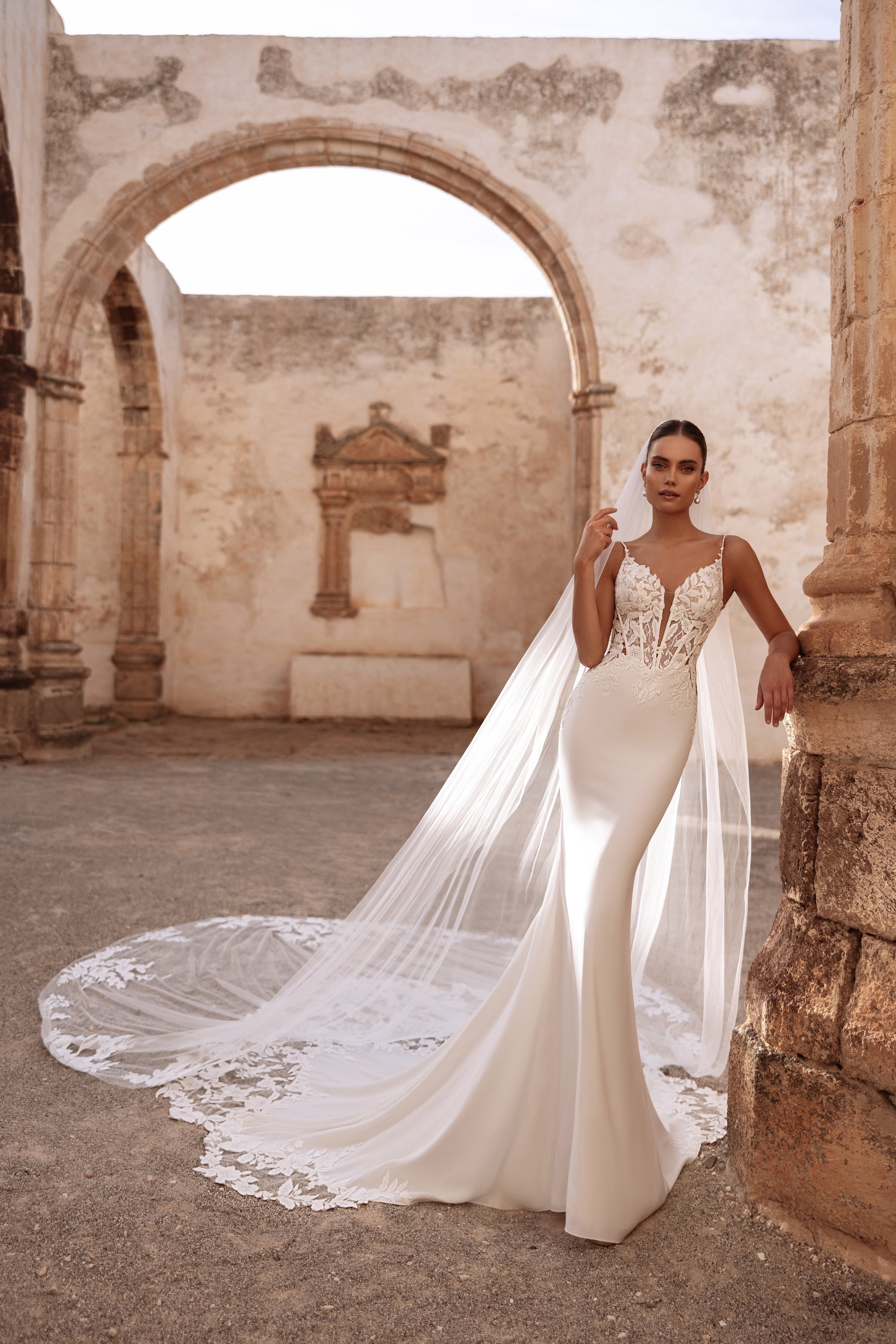 Munira wedding dress with a cathedral veil featuring floral embroidery, perfect for a timeless bridal style.