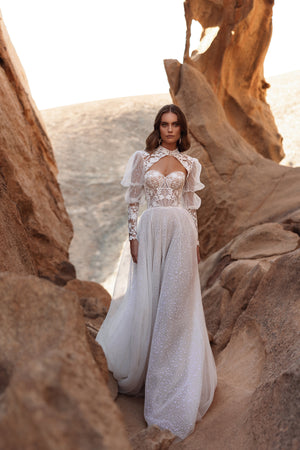 Brautkleid Oasis in ganzer Figur zwischen Sandsteinfelsen, Tüllrock in A-Linie