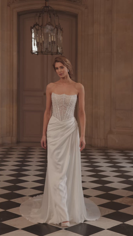 Video of the Greta wedding dress – a richly beaded strapless corset and draped satin skirt.
