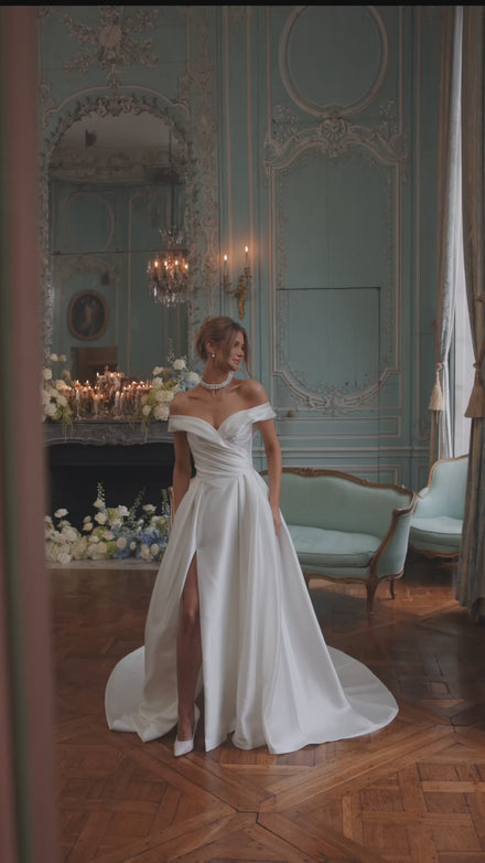 Video of the Heloise wedding dress in motion – A-line silhouette with a softly draped off-the-shoulder neckline in clean satin.