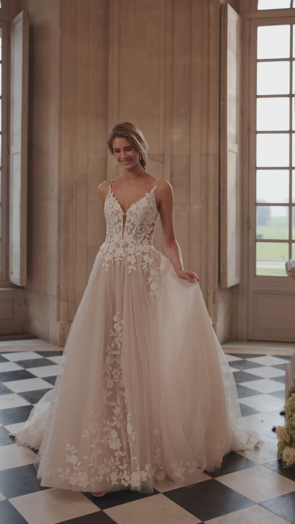 Video of the Solene wedding dress in motion – A-line silhouette with delicate straps, an open neckline and floral lace appliqués.