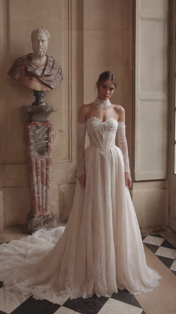 Video of the Blanche wedding dress in motion – A-line silhouette with a beaded corset, soft lace skirt and off-the-shoulder sleeves.