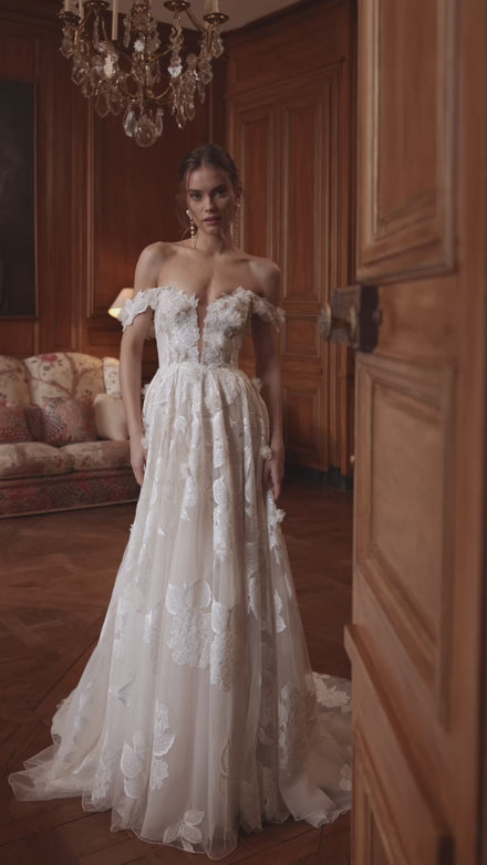 Video of the Hydragenea wedding dress in motion – A-line silhouette with a plunging neckline and off-the-shoulder floral straps.