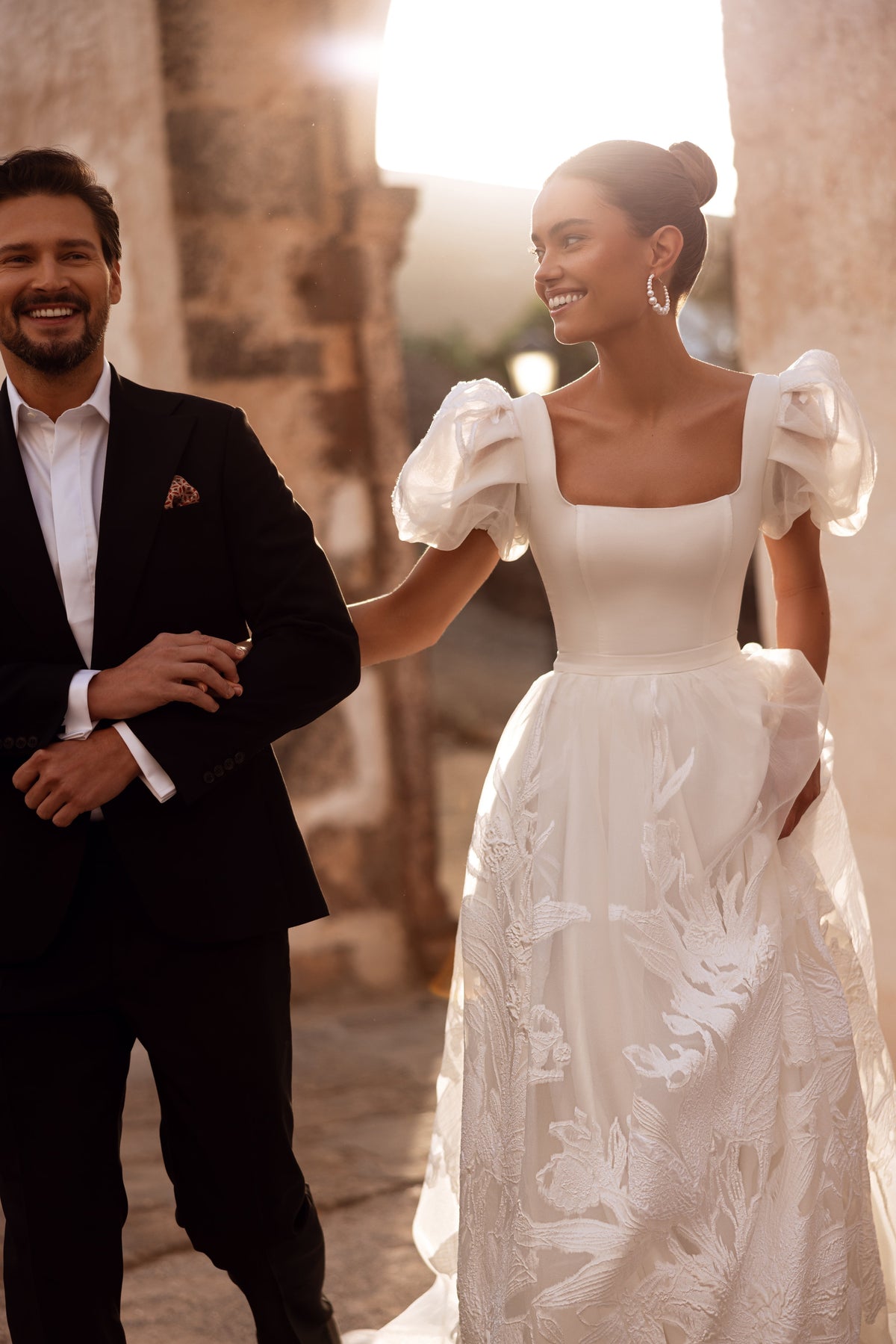 The Vanilla wedding dress with organza puff sleeves and embroidered details creates a dreamy bridal look.